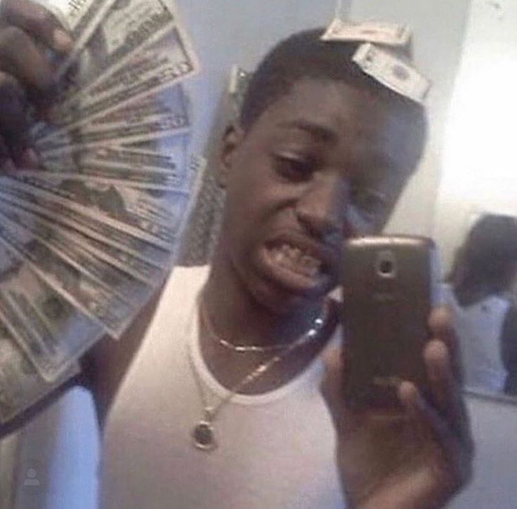 a man holding a cell phone in front of his face with money coming out of it