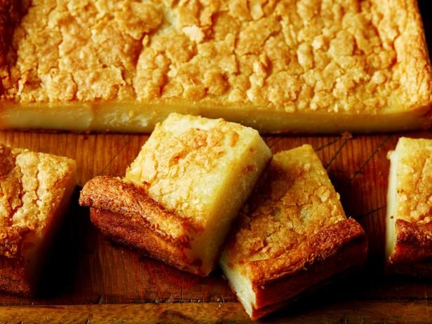 several pieces of cake sitting on top of a wooden cutting board