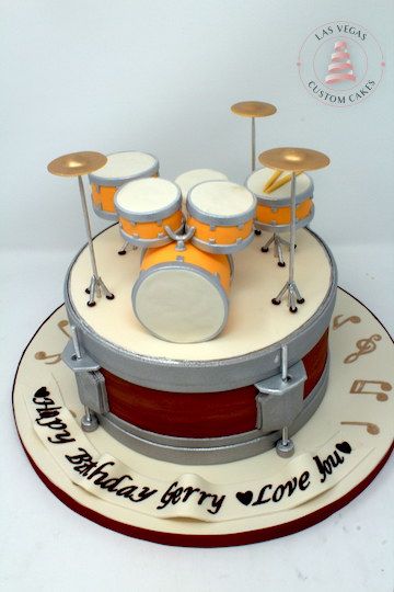 a birthday cake with a drum set on top