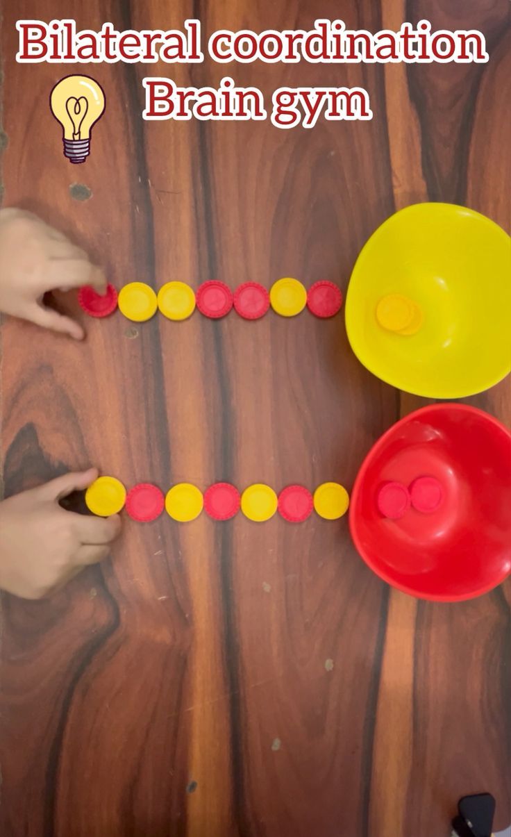 two children playing with wooden beads on a table next to an orange and yellow toy