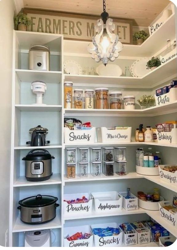 an organized pantry with lots of food and items on shelves, including crockpots