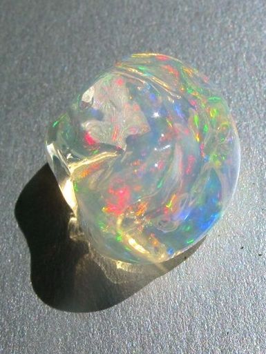 an opalite ring sitting on top of a table