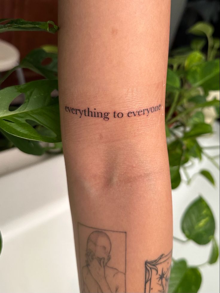 a woman's arm with a tattoo saying everything to everyone on it and an image of a man