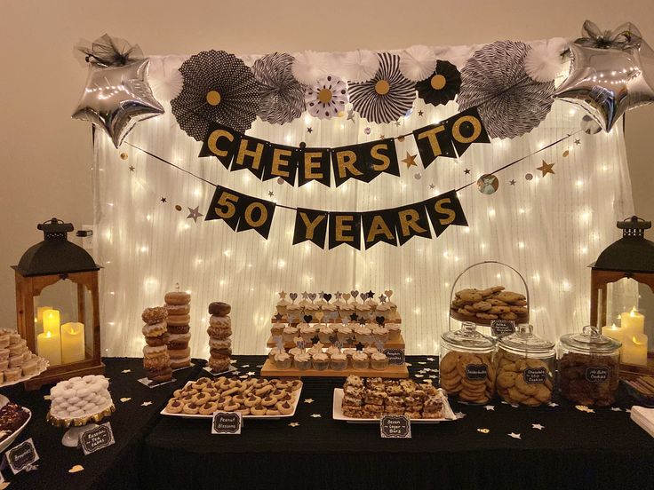 a dessert table filled with cookies and pastries