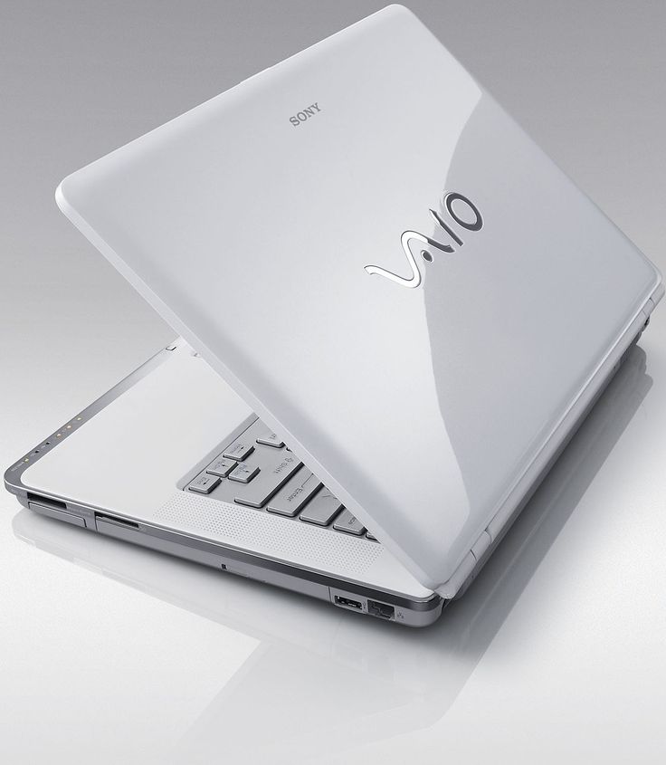 an open laptop computer sitting on top of a white surface with the word omo written on it