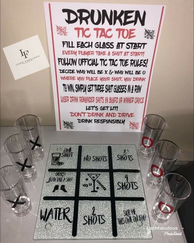 a tic - tac - toe game is set up on a table with glasses