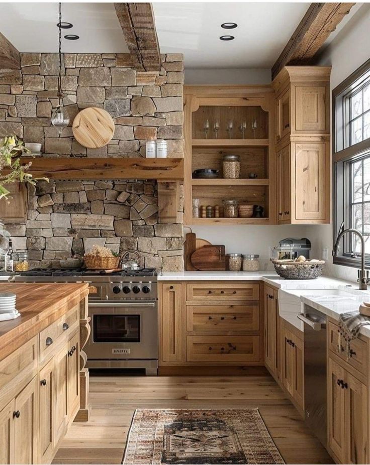 a kitchen with stone walls and wooden cabinets