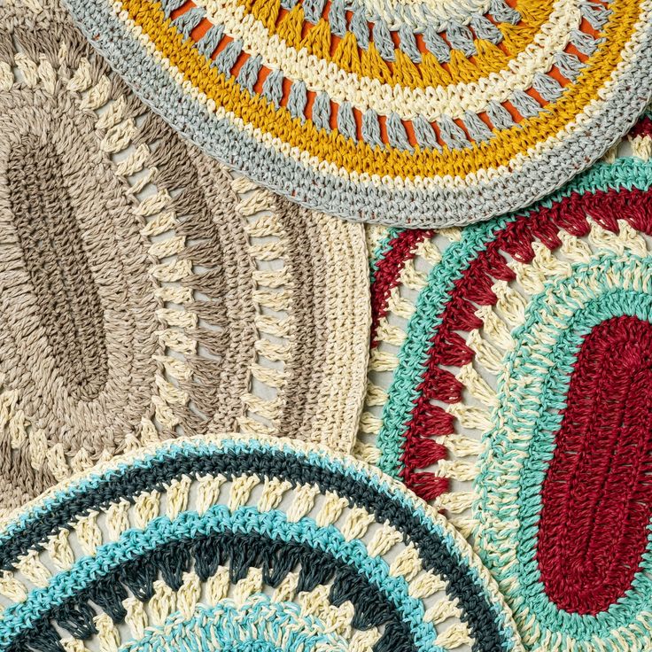 crocheted rugs are arranged on top of each other