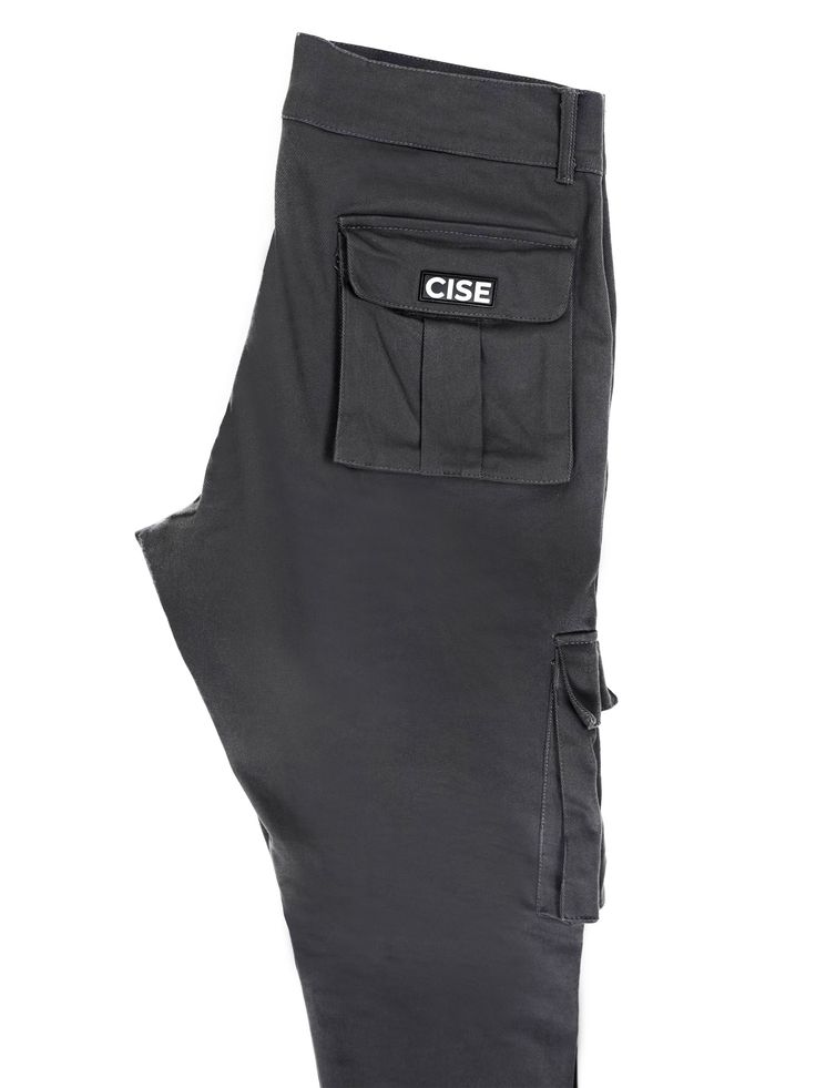 Have what you need, when you need it while sporting the Strategy Cargo Pant. With six pockets overall, two utility pockets on the front and two on the back, there is a pocket for everything. This pant features a comfortable waistband that sits at your natural waist while the legs have a tapered fit. They’re made from 100% cotton making them the perfect pant for everyday wear. This product is unisex and runs true to size. Please refer to the size guide listed on our website to purchase the perfec Gray Pants With Hip Pockets For Outdoor Activities, Gray Pants With Hip Pockets For Outdoor, Gray Bottoms With Functional Pockets For Outdoor, Gray Outdoor Pants With Multiple Pockets, Gray Outdoor Pants With Pockets, Outdoor Gray Cargo Pants, Gray Streetwear Bottoms With Pockets, Gray Pants With Pockets For Outdoor, Gray Bottoms With Pockets For Streetwear