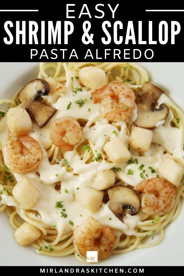 shrimp and scallop pasta with mushrooms in a white sauce on a white plate