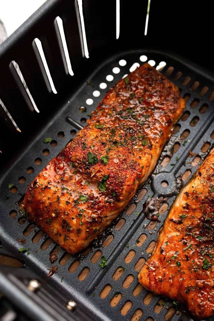 two pieces of cooked meat sitting on top of a grill