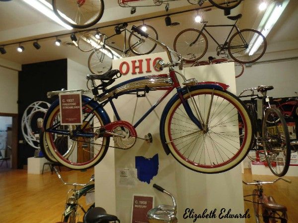 there are many bikes on display in the room with signs above them that read ohio