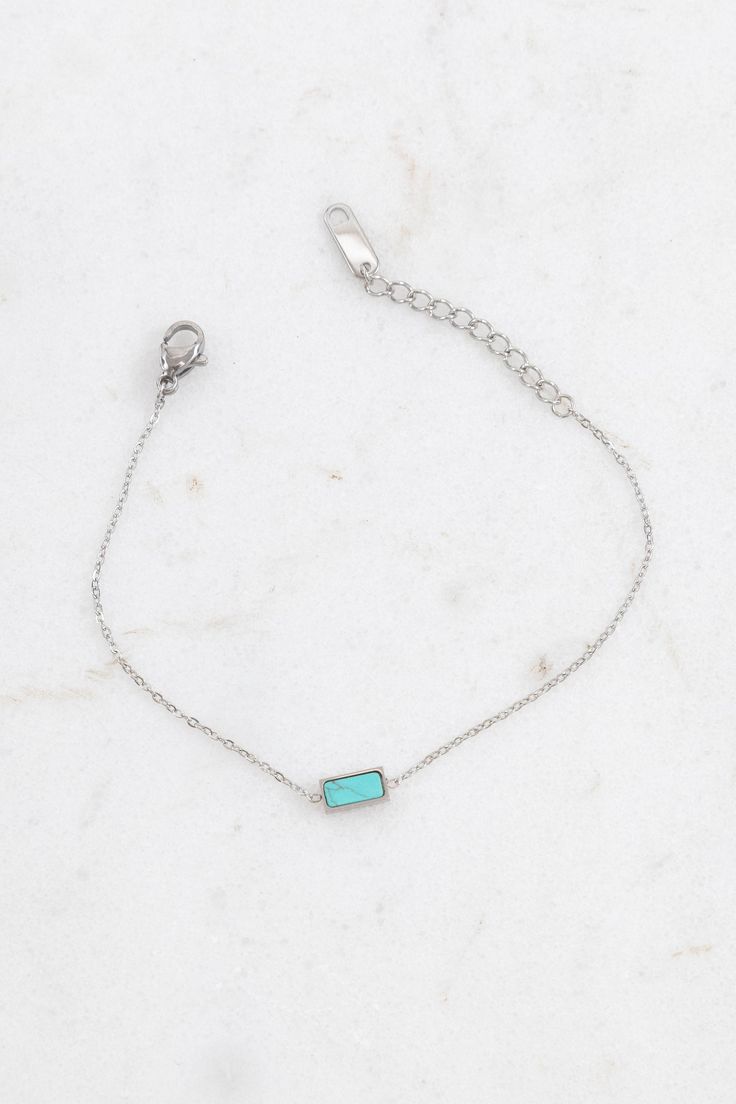 Polished silver with an elegantly laid marble stone. Each stone is unique - color may vary. Available in white, black, and turquoise. Lobster clasp stainless steel Measurements: Length: 6 in. / 15.24 cm. Extension: 1.75 in. / 4.44 cm. Pendant: .25 in. / .63 cm. Dainty Stainless Steel Bracelet, Minimalist Silver Jewelry With Rectangular Stone, Elegant Turquoise Birthstone Bracelets, Minimalist Jewelry With Rectangular Birthstone, Modern Stainless Steel Jewelry With Extender, Minimalist Rectangular Birthstone Jewelry, Minimalist Metal Jewelry With Gemstone, Minimalist Metal Gemstone Jewelry, Elegant Turquoise Jewelry With Rectangular Stone