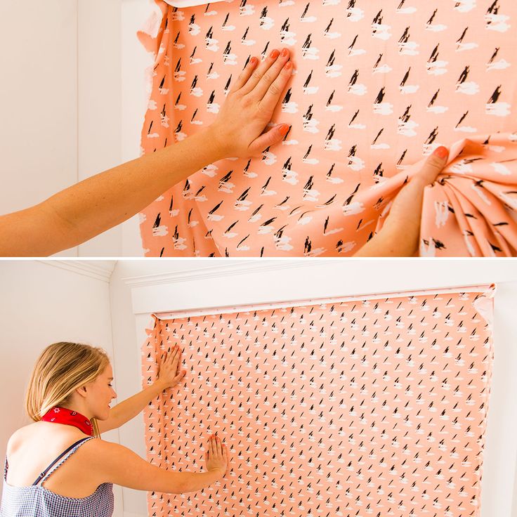 a woman is placing fabric on the wall to make it look like she's making something