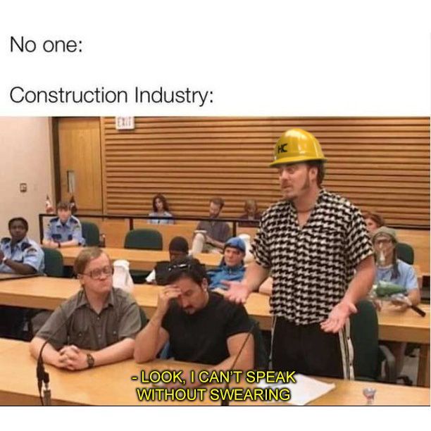 a man wearing a hard hat standing in front of a class room full of students