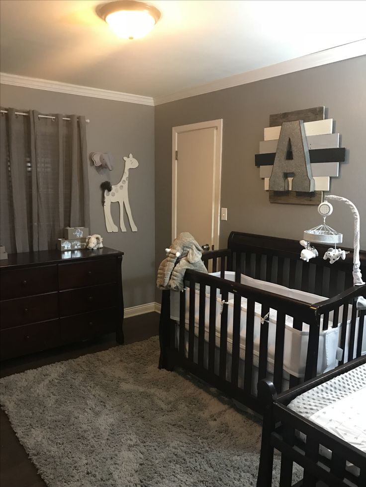 a baby's room with two cribs in it