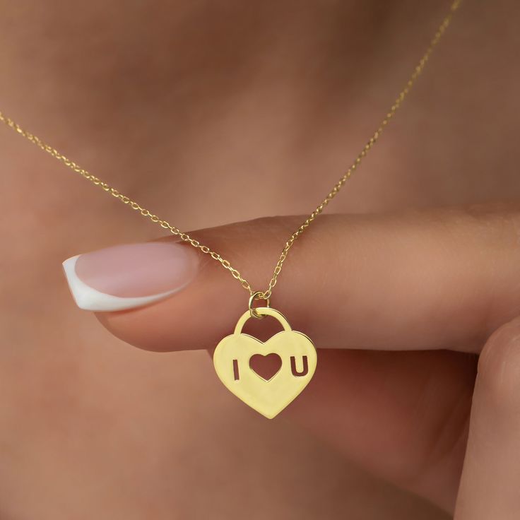 "This stunning 14K gold necklace is the perfect gift for your significant other.  The romantic padlock heart design symbolizes your love and commitment to each other, while the custom \"I Love You\" engraving adds a personal touch that will touch your soulmate's heart. Whether you're celebrating a special occasion or just want to show your love and appreciation, this necklace is an ideal gift that will make a lasting impression.  It comes in a beautiful gift box, making it a perfect present for I Love You Necklace, Engraved Charm Necklaces For Valentine's Day, Engraved Charm Necklace For Valentine's Day, Meaningful Heart Charm Necklaces For Valentine's Day, Meaningful Heart Charm Necklace For Valentine's Day, Engraved Charm Necklaces For Her On Valentine's Day, Heart-shaped Charm Necklace For Mother's Day, Personalized Charm Necklace For Valentine's Day, Heart Lock Necklace