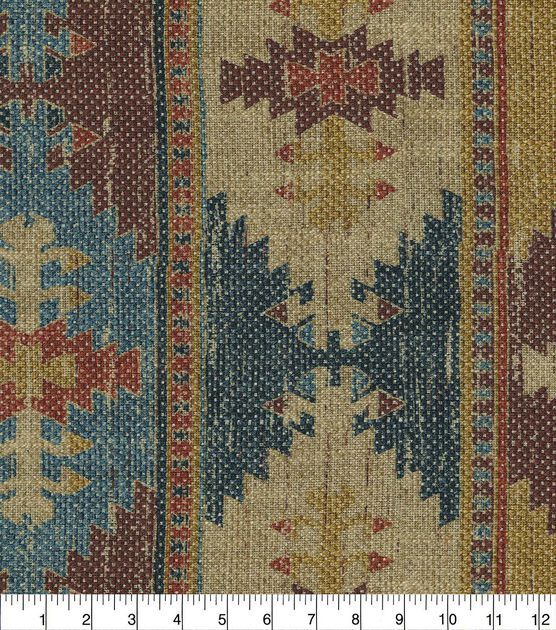 an old rug with many different colors and patterns on the side, as well as a ruler