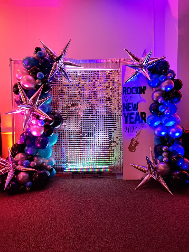 balloons and star decorations in front of a backdrop