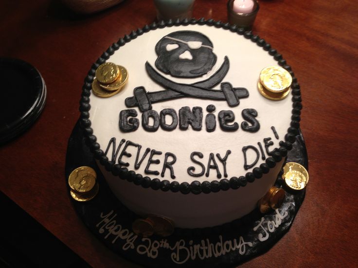 a birthday cake that says goonies never say die on the side with gold coins around it