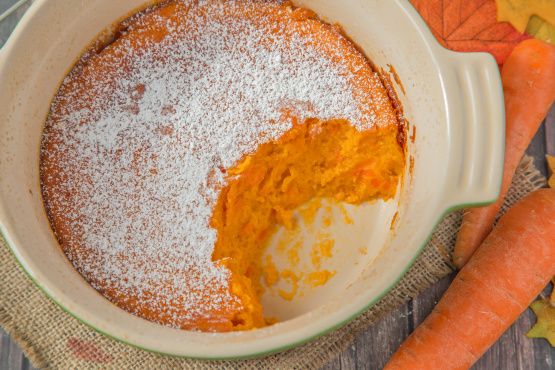 carrots and powdered sugar in a bowl on a table with other food items