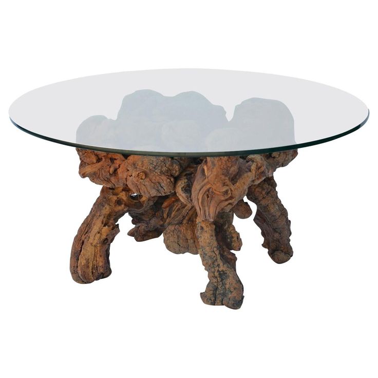 a glass table topped with wood pieces and a round glass top on an isolated white background