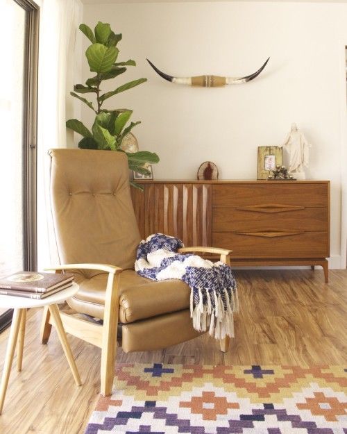 a living room filled with furniture and a plant