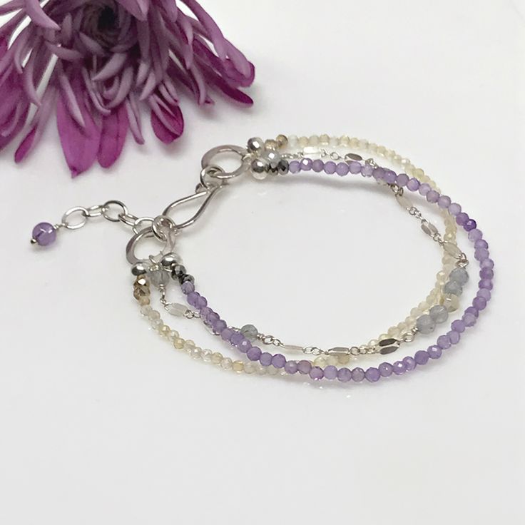 Layered gemstone bracelet is sure to become a favorite. Not only do gray sapphire and citrine gemstones adorn this classic bracelet set…but amethyst gemstones do as well. First, petite sapphire gemstones, which are softly hued, sit between sections of dapped Argentum silver chain. Second, luscious citrine gemstones make up another strand. Third, you’ll find delicate amethyst stones making the last layer. These beauties are also softly hued and translucent. Elegant Gemstone Beaded Bracelets For Friendship, Elegant Adjustable Crystal Friendship Bracelet, Elegant Adjustable Crystal Bracelet For Friendship, Delicate Silver Bracelets With Ethical Gemstones, Elegant Faceted Bead Friendship Bracelet, Adjustable Faceted Crystal Bracelet For Everyday, Elegant Adjustable Bracelets For Friendship, Elegant Adjustable Bracelet For Friendship, Elegant Double Strand Gemstone Beads Bracelets