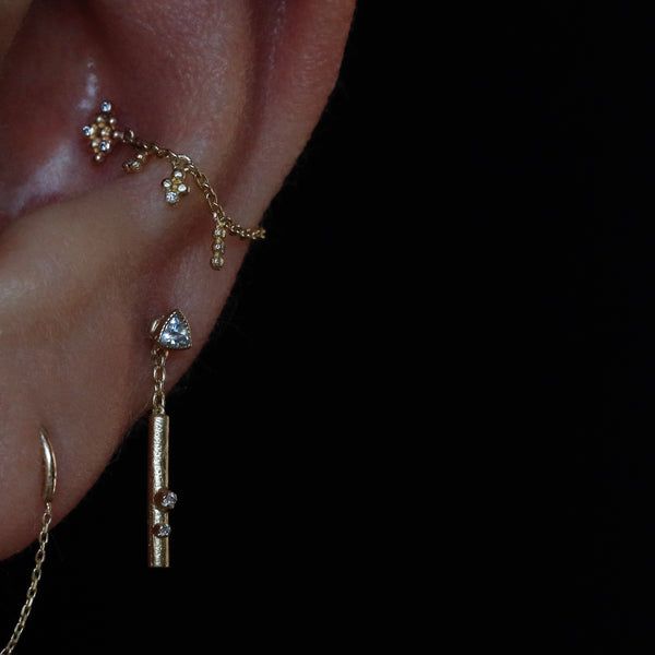 a person wearing ear piercings with chains attached to them