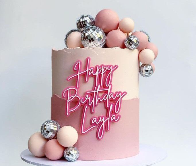 a birthday cake with pink frosting and silver balloons on the top that says happy birthday lady