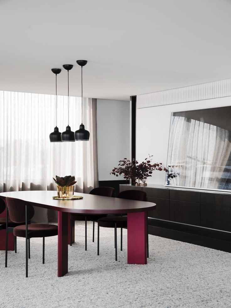 a dining room table and chairs in front of a large window with sheer drapes