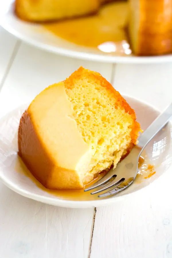 a slice of pound cake on a plate with a fork and knife next to it