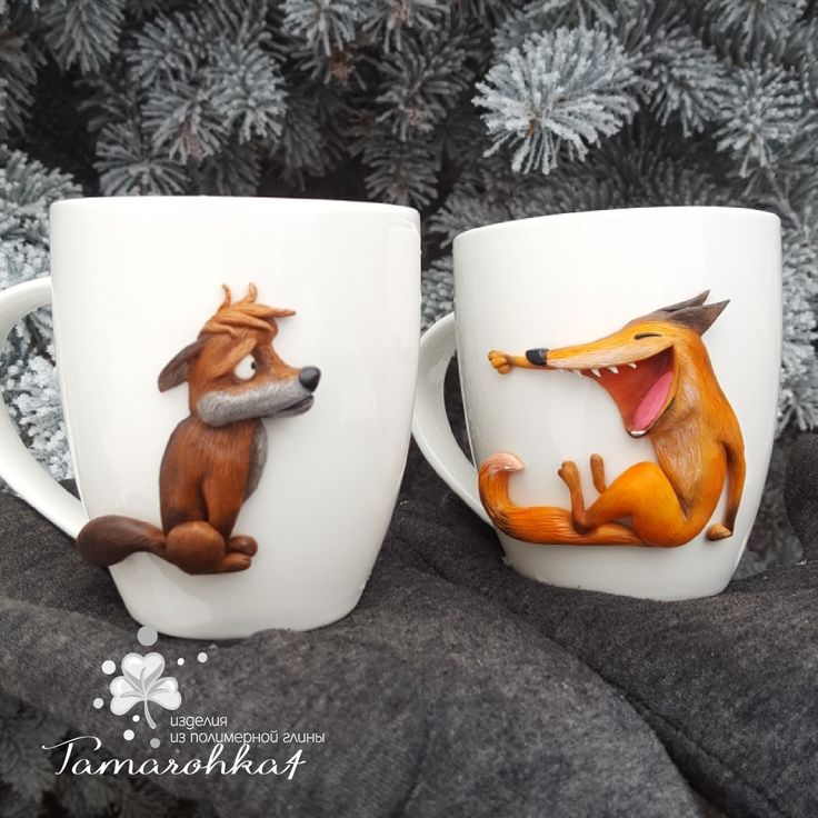 two coffee mugs that have animals on them