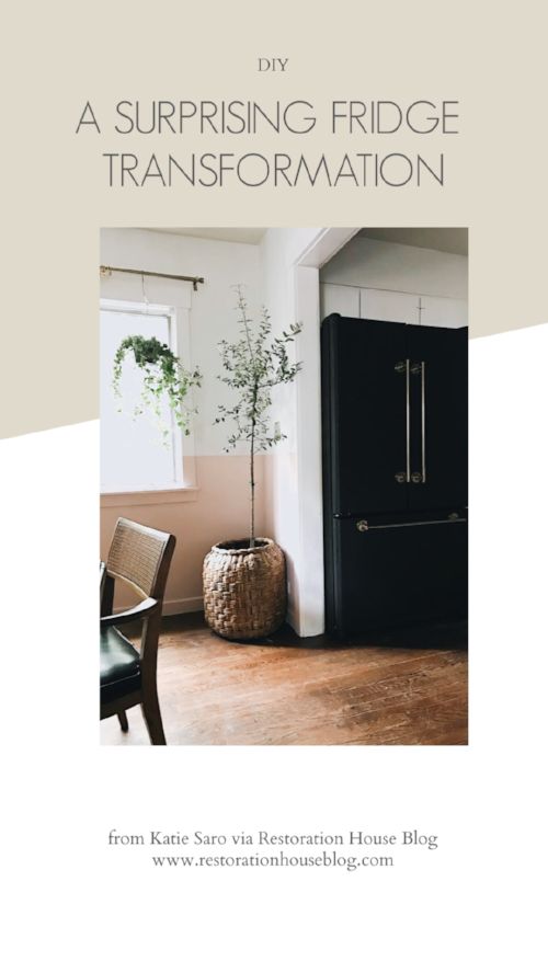 a black refrigerator sitting in the corner of a room