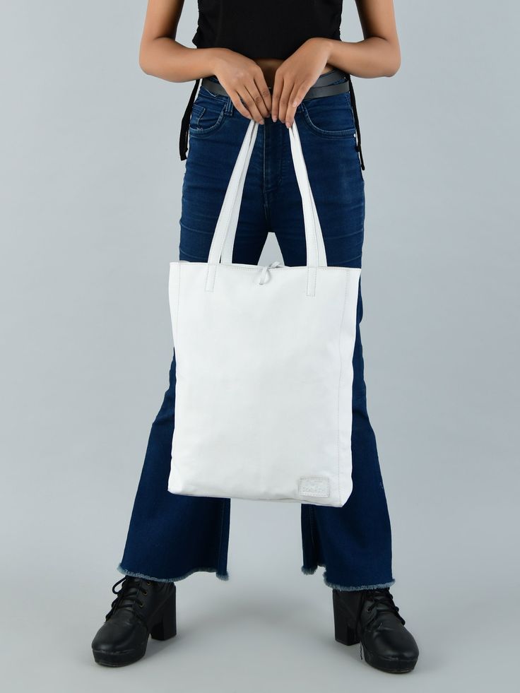 Step out in style and confidence with this iconic white leather shoulder tote bag, a classic embodiment of grace and functionality. Handcrafted by skilled artisans, it radiates timeless craftsmanship. Crafted from full-grain buffalo soft leather, it blends durability with an enduring charm. The secure zipper closure safeguards your essentials, while a thoughtfully designed inside pocket organizes coins, keys, purse, or your phone. Ideal for office use, it accommodates tablets or small laptops wi White Shoulder Bag With Leather Handles For On-the-go, White Leather Bags With Zipper Closure, White Smooth Grain Leather Bags, White Satchel With Smooth Grain, White Soft Leather Shoulder Bag With Double Handle, Modern White Shoulder Bag With Zipper Pocket, Classic White Shoulder Bag With Leather Handles, Everyday White Shoulder Bag With Zipper Closure, Classic White Soft Leather Shoulder Bag