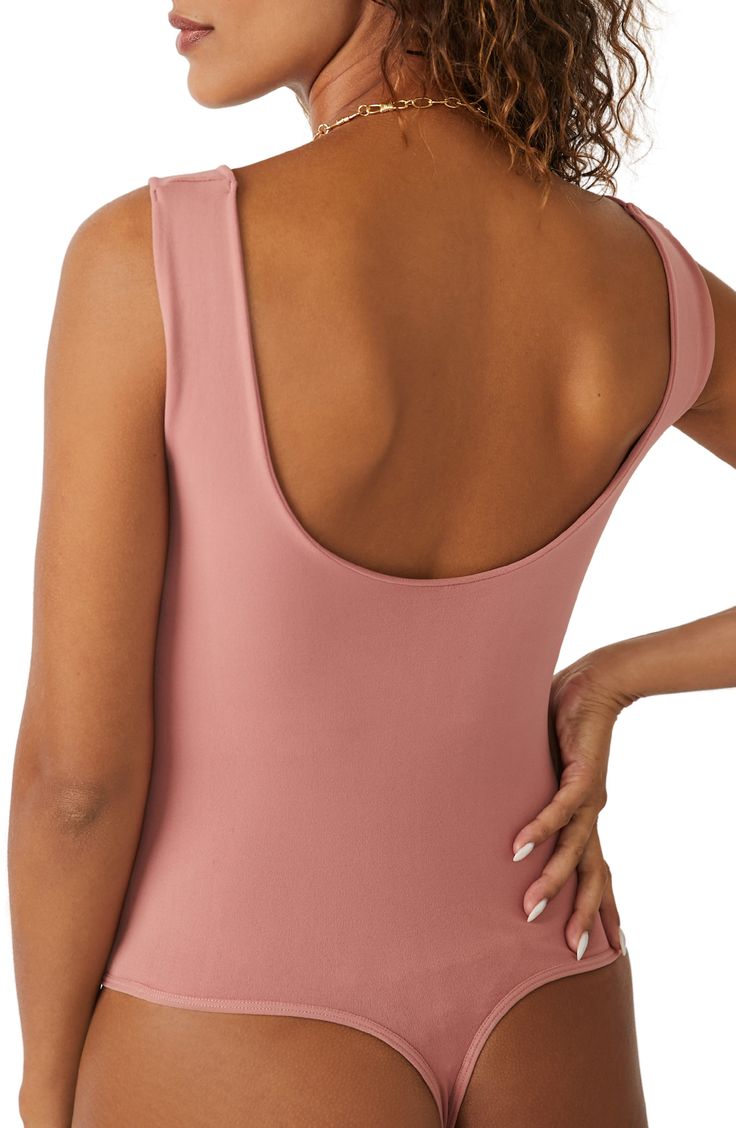 A sleek curve-hugging bodysuit featuring a dipped neckline and low U-back. Stretch fit Built-in shelf bra Snap gusset closure Thong cut 92% nylon, 8% elastane Machine wash, dry flat Imported Pink Sleeveless Second-skin Bodysuit, Stretch Leotard With Built-in Bra And Scoop Neck, Pink Sleeveless Nylon Bodysuit, Stretch Nylon Bodysuit With Scoop Back, Nylon Bodysuit With Built-in Bra And Scoop Neck, Fitted Backless Tank Top With Lined Body, Solid Color Scoop Back Leotard, Contoured Bodysuit With Built-in Bra, Second-skin Fit Backless Leotard