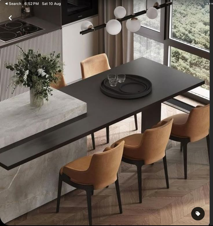 a dining table with chairs around it in front of a window and a stove top oven