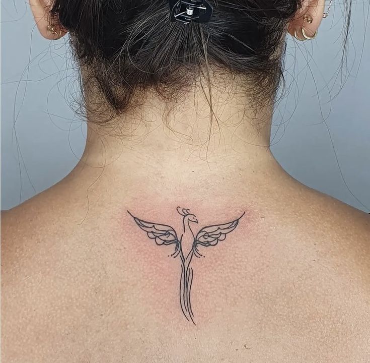 a woman with a tattoo on her back neck