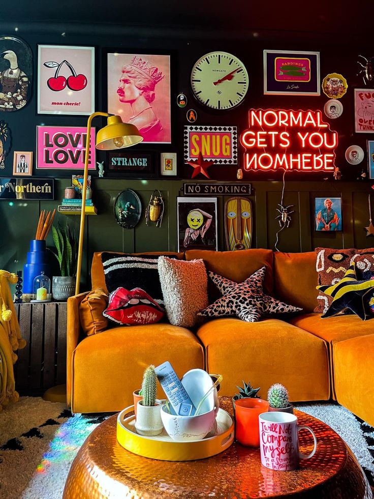 a living room filled with lots of furniture and pictures on the wall next to a coffee table