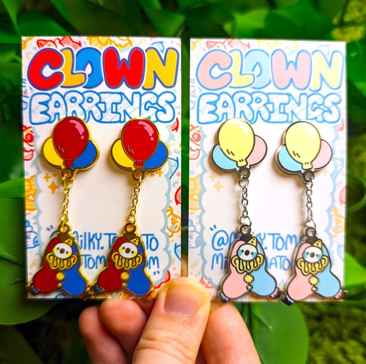 ❤ DANGLING CLOWN EARRINGS ❤ ♡ These silly lil guys really have a handle on things! ♡ These cute lil dangling clowns are adorable earrings in gold and/or silver, saturated or pastel! ♡ Art is made by me :) ♡ Sizes: - 2.5x1" ♡ Materials: - Nickle free copper ♡ SHIPPING & RETURNS ♡ - Please allow 1-4 business days for processing and shipping your order! - This item ships in a bubble padded mailer. - No returns or exchanges will be accepted and I am not responsible for any delayed or lost packages. Clown Earrings, Silly Clothes, Weird Jewelry, Cute Clown, Clowning Around, Funky Jewelry, Earrings In Gold, Pastel Art, Cute Pins