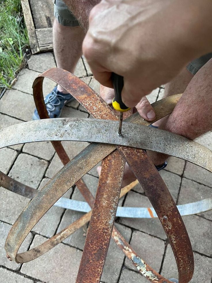 a man is working on an old metal object