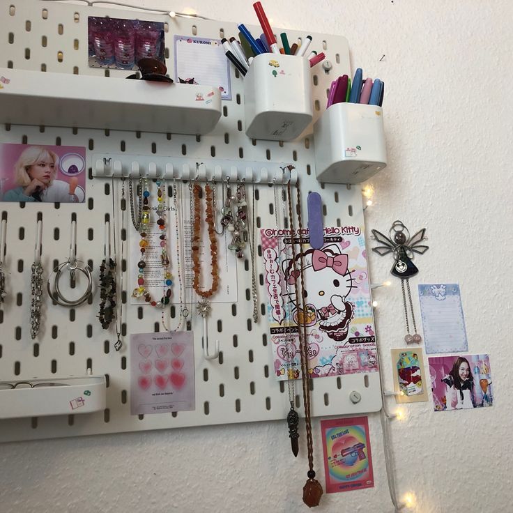 a white pegboard with lots of jewelry hanging on it