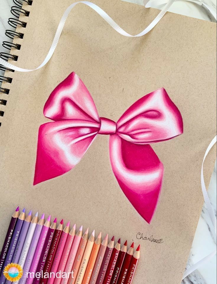 a drawing of a pink bow with colored pencils next to it