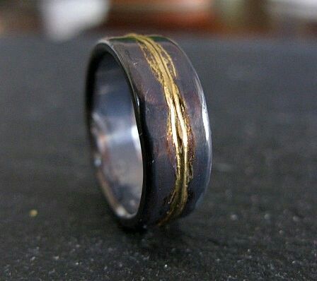 a wedding ring with gold lines on it