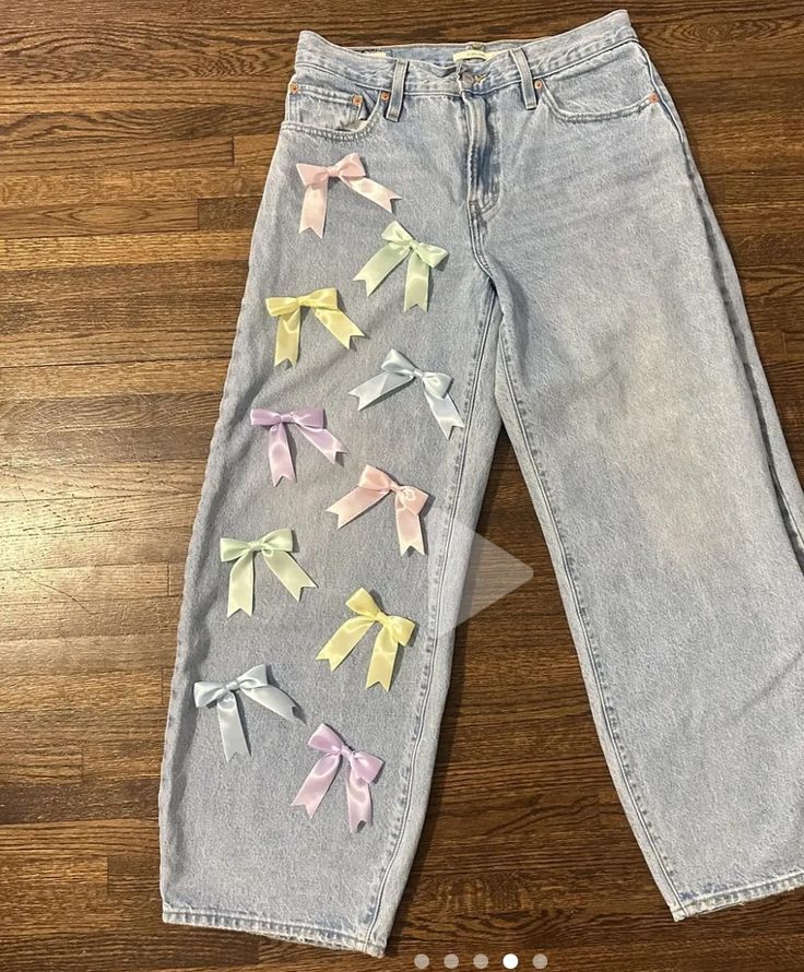 a pair of jeans with bows on them