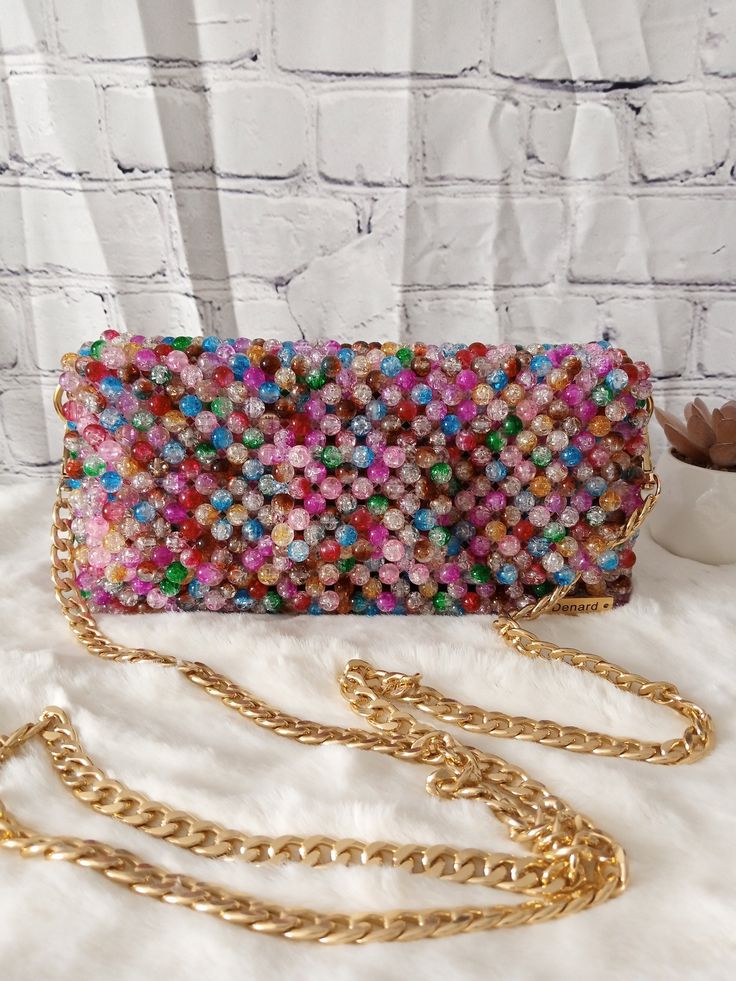 Carry a little extra sparkle wherever you go with this stunning beaded bag. Bags are 100% handmade. Dimension: Width: 21.5cm Height: 11cm Depth: 6cm The bag comes with a chain handle which measures 110cm. Feel free to contact me for any questions. Multicolor Embellished Pouch Evening Bag, Handheld Beaded Clutch, Trendy Handmade Shoulder Bag For Party, Trendy Handheld Beaded Evening Bag, Multicolor Beaded Rectangular Evening Bag, Trendy Beaded Evening Bag As Gift, Beaded Clutch Shoulder Bag As Gift, Beaded Clutch Shoulder Bag For Gifts, Trendy Beaded Evening Bag Perfect As A Gift