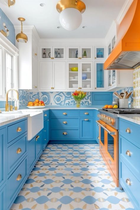 a kitchen with blue and orange cabinets, white counter tops, and gold trimmings