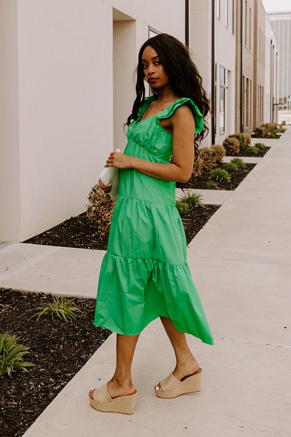 - This sweet dress is perfect for a sunny day! - Lightweight, green hued material with a lined bust - A scoop neckline - A bust with gathered detail - Flutter sleeves with elastic shoulders - A smocked upper back - A relaxed silhouette that ends in a straight midi length hemline Green Ruffled Straps Vacation Dress, Green Vacation Dress With Ruffled Straps, Green Ruffle Hem Dress For Day Out, Green Spring Dresses With Ruffled Straps, Spring Green Dresses With Ruffled Straps, Green Dresses With Ruffled Straps For Spring, Green Midi Dress With Ruffles For Beach, Green Summer Midi Dress With Gathered Neckline, Green Midi Dress With Ruffle Hem For Beach