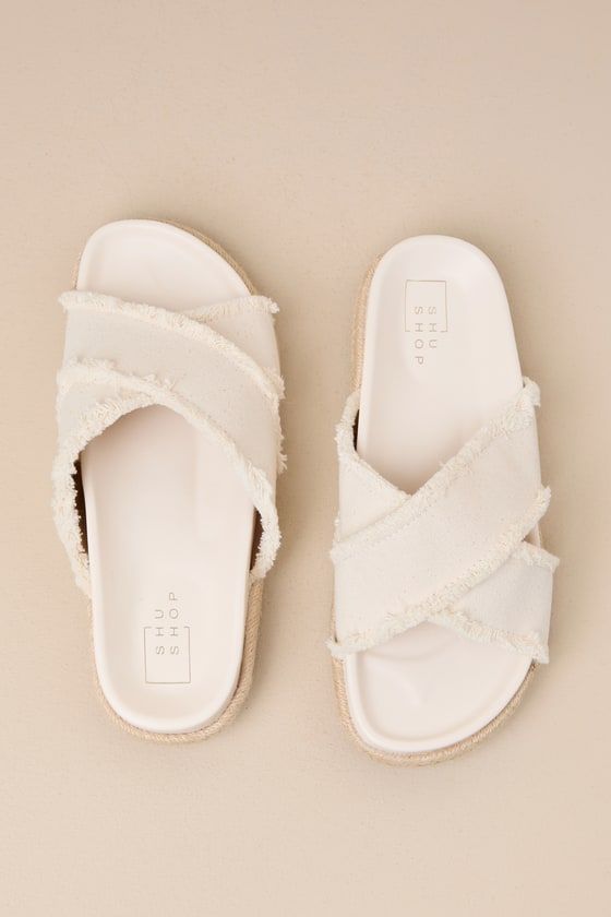 Compliments are guaranteed when you pair any of your favorite summer looks with the Shu Shop Courtney Bone Flatform Slide Sandals! These too-cute sandals feature an almond-shaped footbed and wide, frayed fabric straps that crisscross atop a peep-toe upper. The espadrille-wrapped flatform sole lends an extra-summery finish to the look, while the simple slide-on contoured design makes for easy styling! 0. 75" espadrille-wrapped sole. Smooth insole. Felted rubber sole has nonskid markings. Man Made Summer Textile Sandals For Vacation, Spring Fabric Sandals With Cushioned Footbed, Textile Beach Sandals For Summer, Beige Textile Sandals For Vacation, Beige Textile Sandals For Summer, Summer Beige Textile Sandals, Beige Sandals With Woven Sole, Beige Textile Sandals With Woven Sole, Adjustable Textile Sandals For Vacation