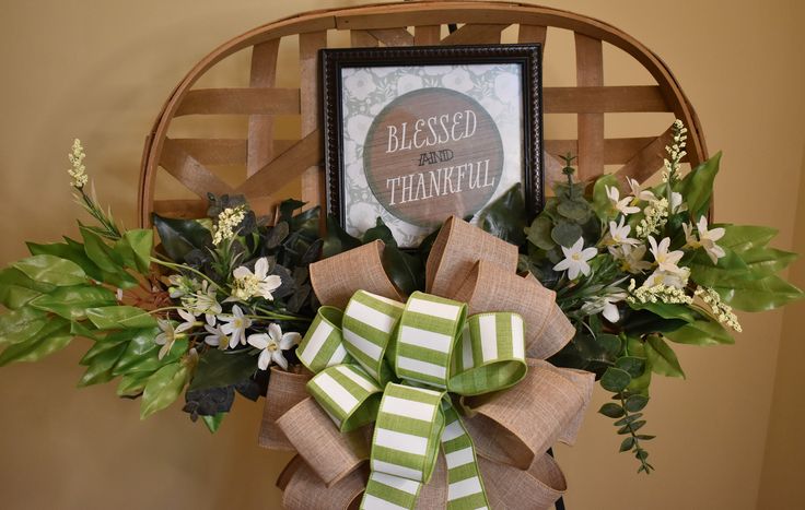 a green and white bow on a chair with a framed sign in the back ground